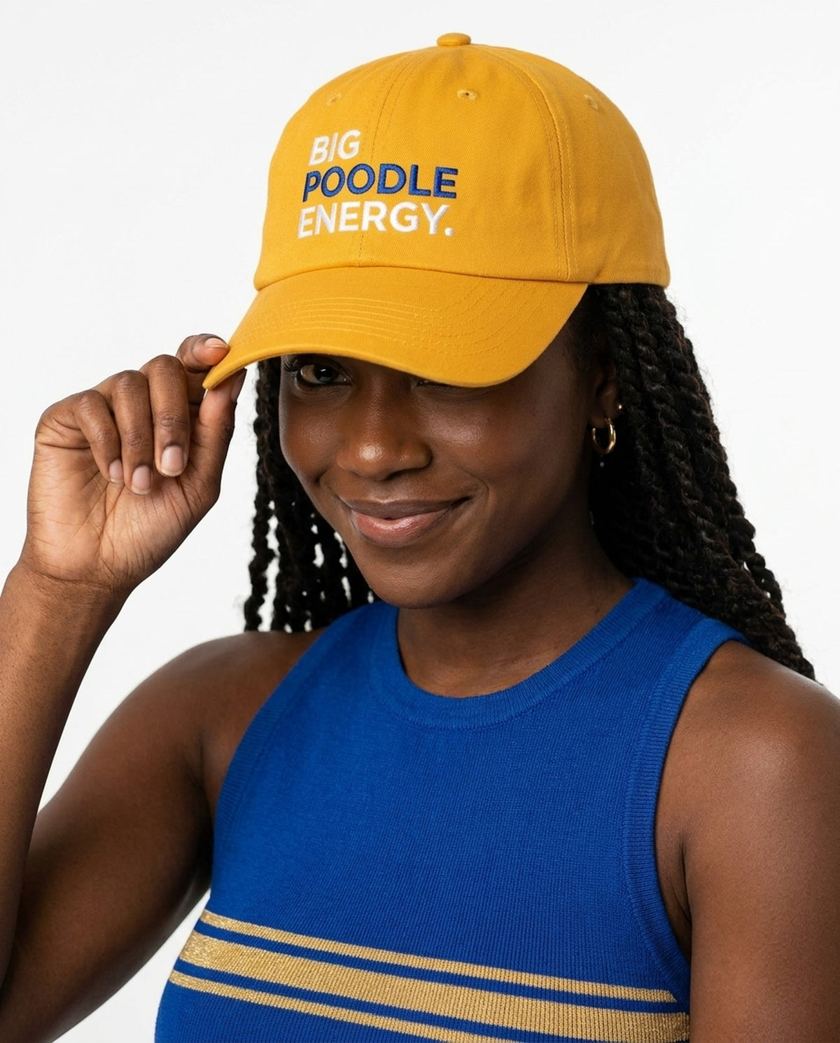 Big Poodle Energy Hat in gold, hand at the brim