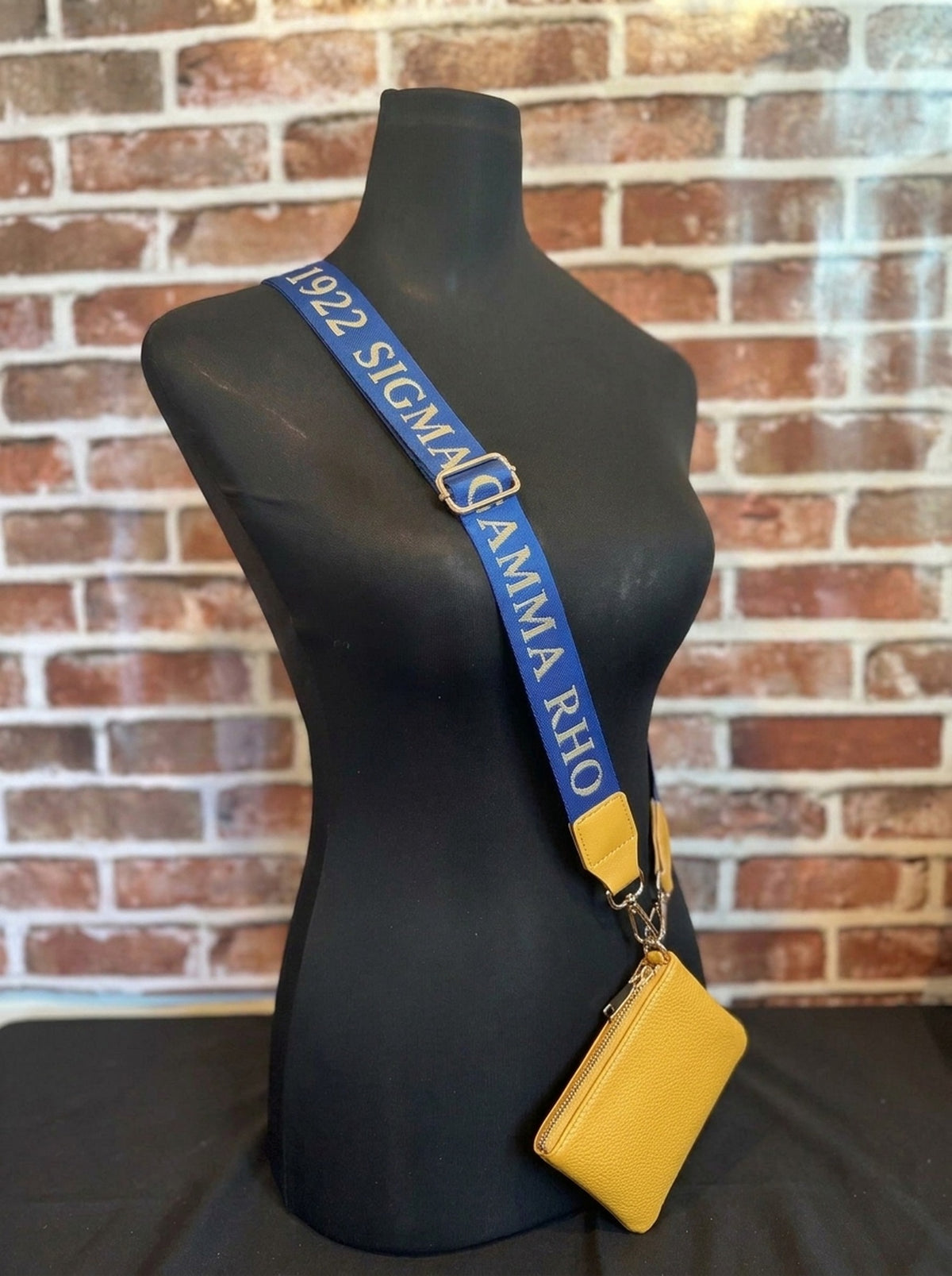Sigma Gamma Rho purse strap worn crossbody with the gold coin wallet
