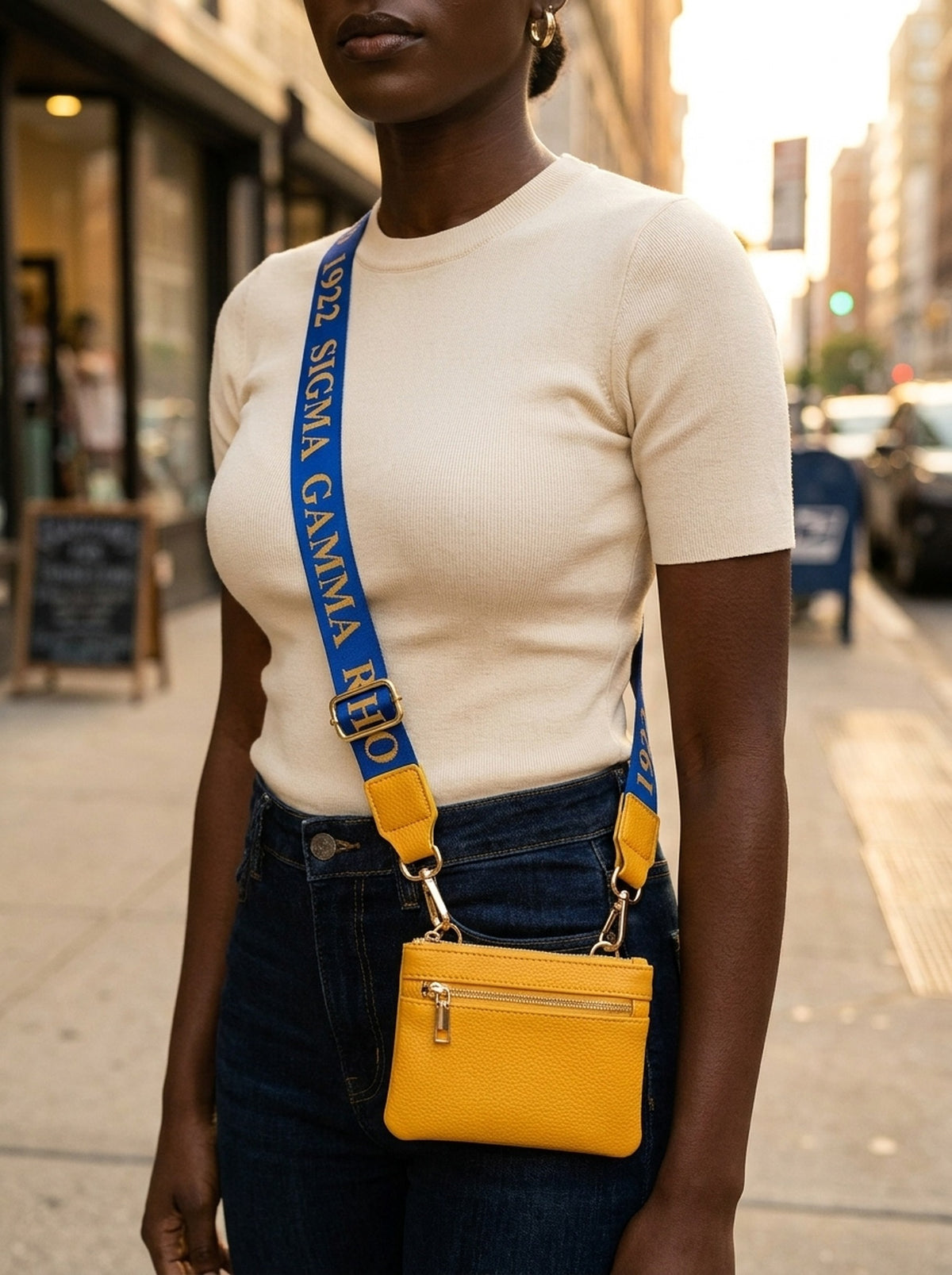 Sigma Gamma Rho purse strap worn crossbody on a city street